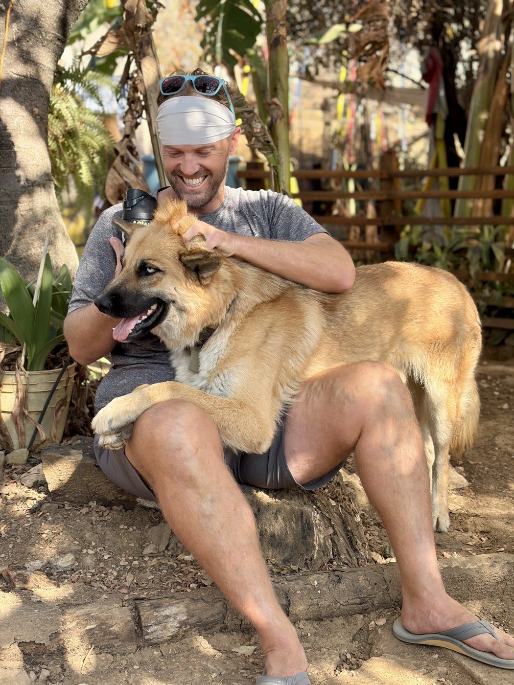 Smiling man sitting with the dog