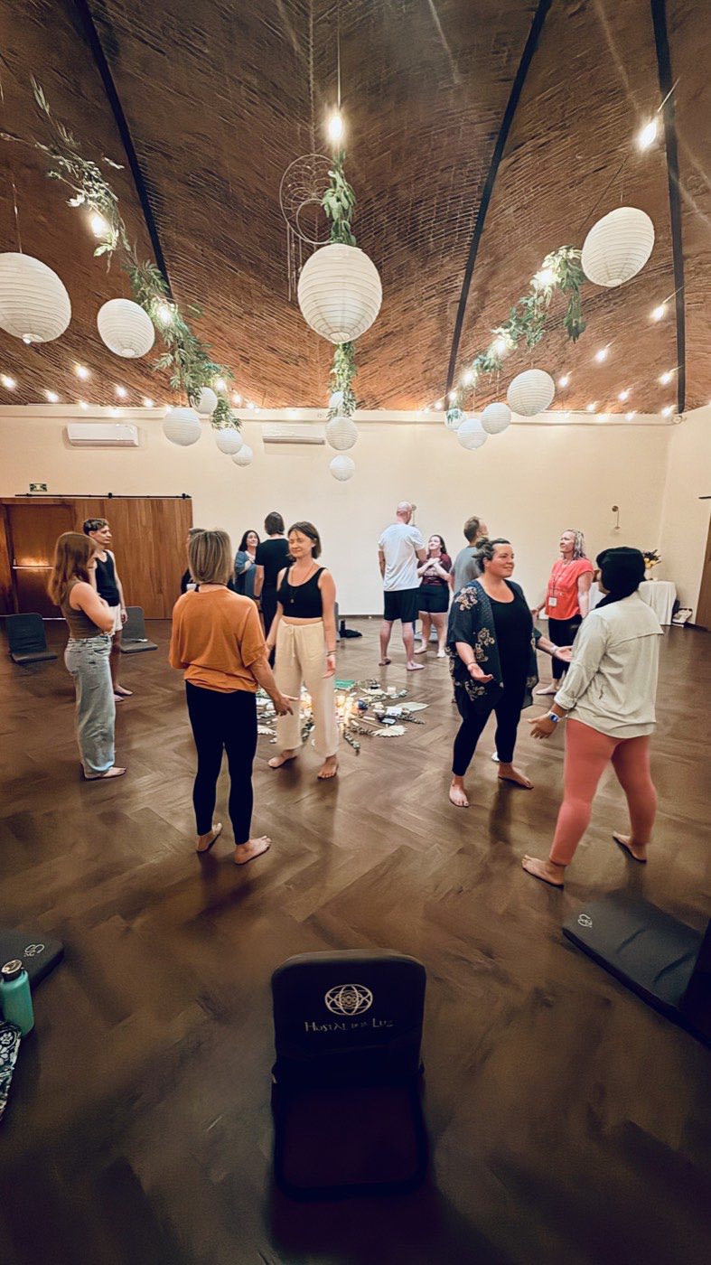 Participants in pairs looking into each other’s eyes in the retreat room