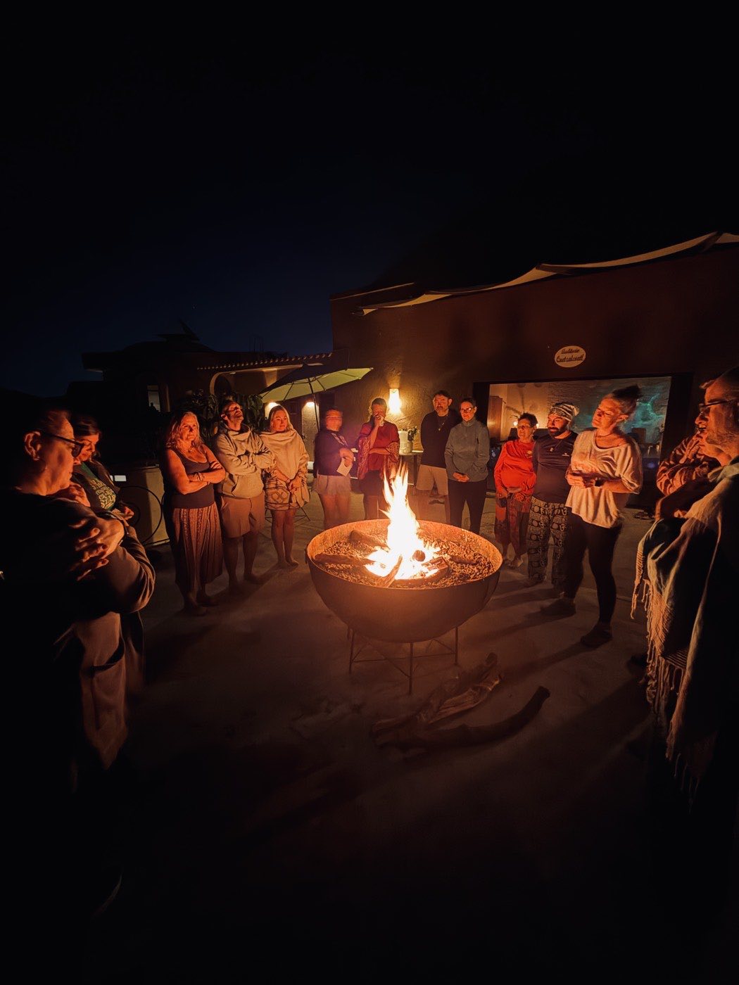 People standing around the glowing fire bowl