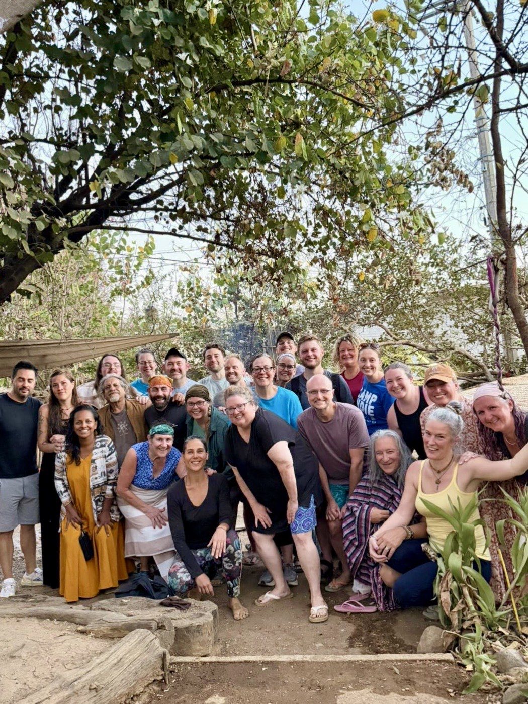 Smiling group beneath the trees